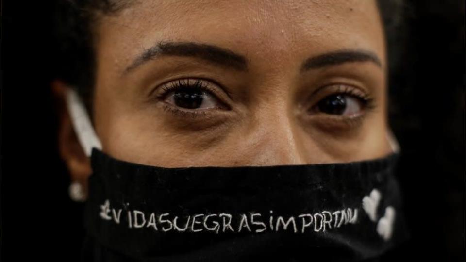 woman wearing a mask reading Black Lives Matter